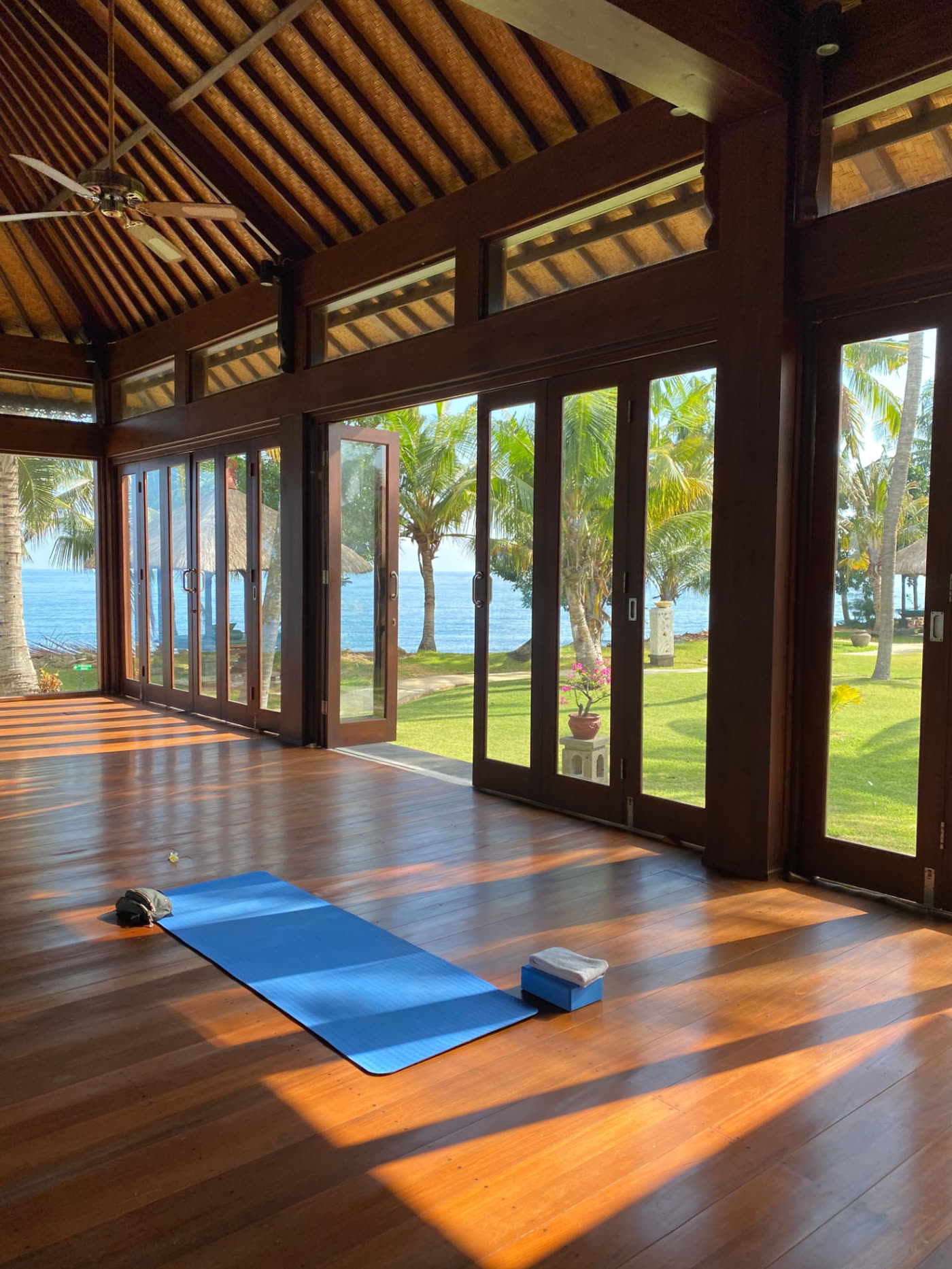 An open-air wellness pavilion set above the ocean